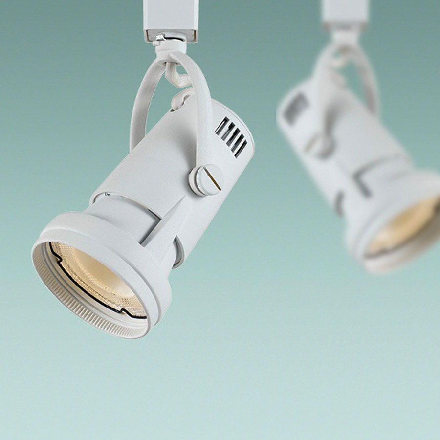 Track lighting heads directed at a gallery wall